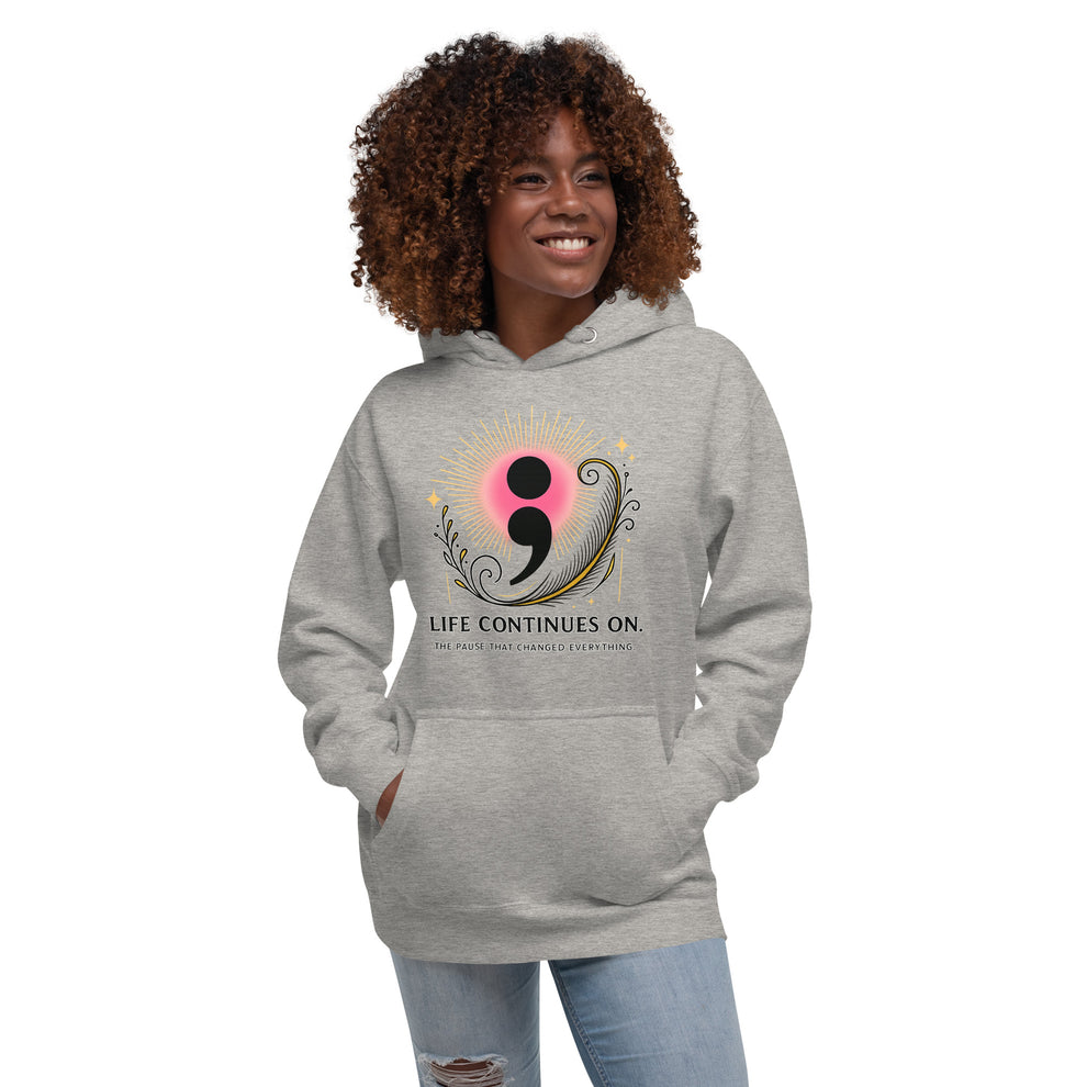 Woman wearing gray hoodie featuring a pink and gold semicolon design with “Life Continues On” text.